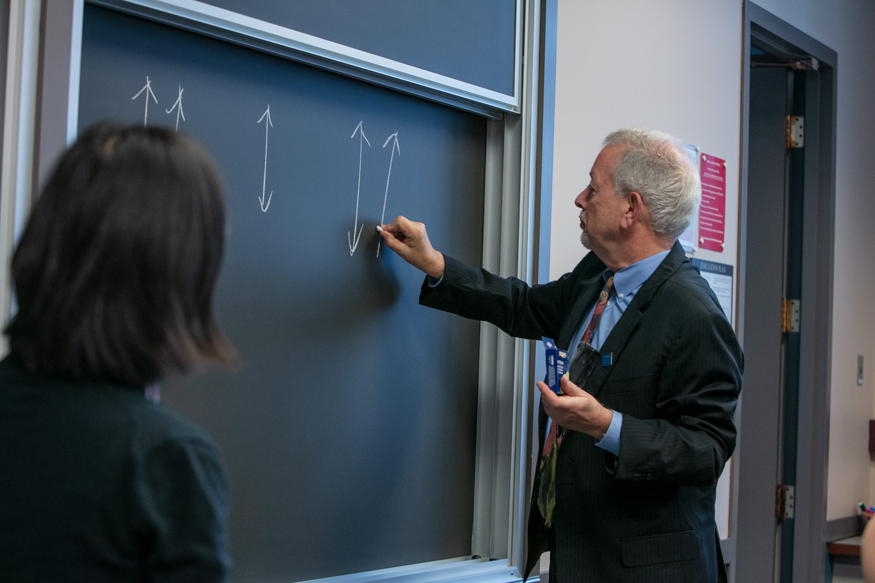 Paul Zionts writes different learning styles to help tecahers from Beijing, China learn how students can interpret various class lectures. (DePaul University/Randall Spriggs)